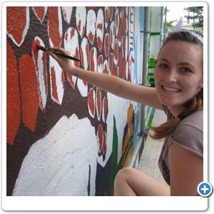 Zoe Daniel working on the 'Bald Eagle' area of the mural.