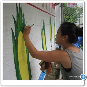 Mural artist Jimin Choe painting on the ears of maize. Our unacknowledged roots among the indigenous peoples is demonstrated along the lower portion of the mural.
Not only did the mainly matrilineal Eastern nations honor the power of the female, but their balanced approach to their environment also led to sustainable practices that honored the seventh generation, and maintained commerce without despoiling the land.	